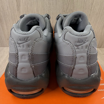 Nike Air Max 95 trainers grey with black accents and textured material.