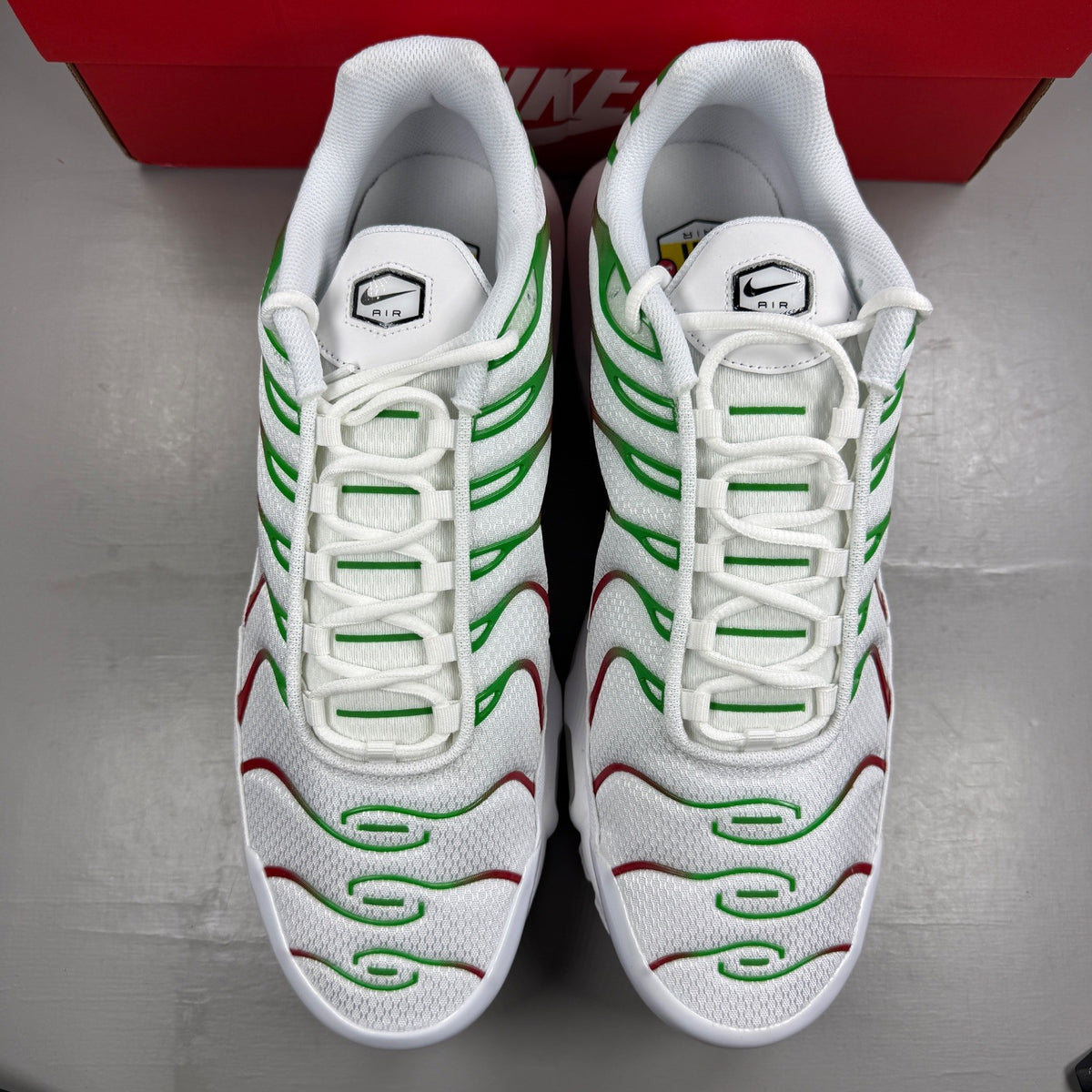 Nike deck shoes white with green and red accents, featuring logo and sleek design.