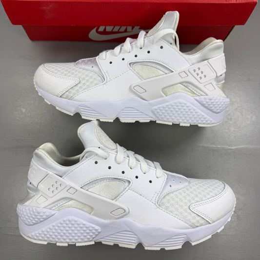 Nike athletic shoes white mesh upper with signature logo and cushioned sole.