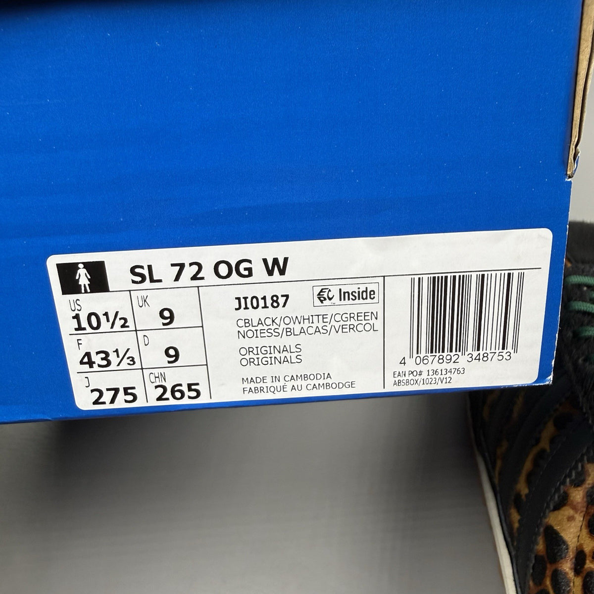 Adidas black trainers with leopard print accents and classic three-stripe logo.