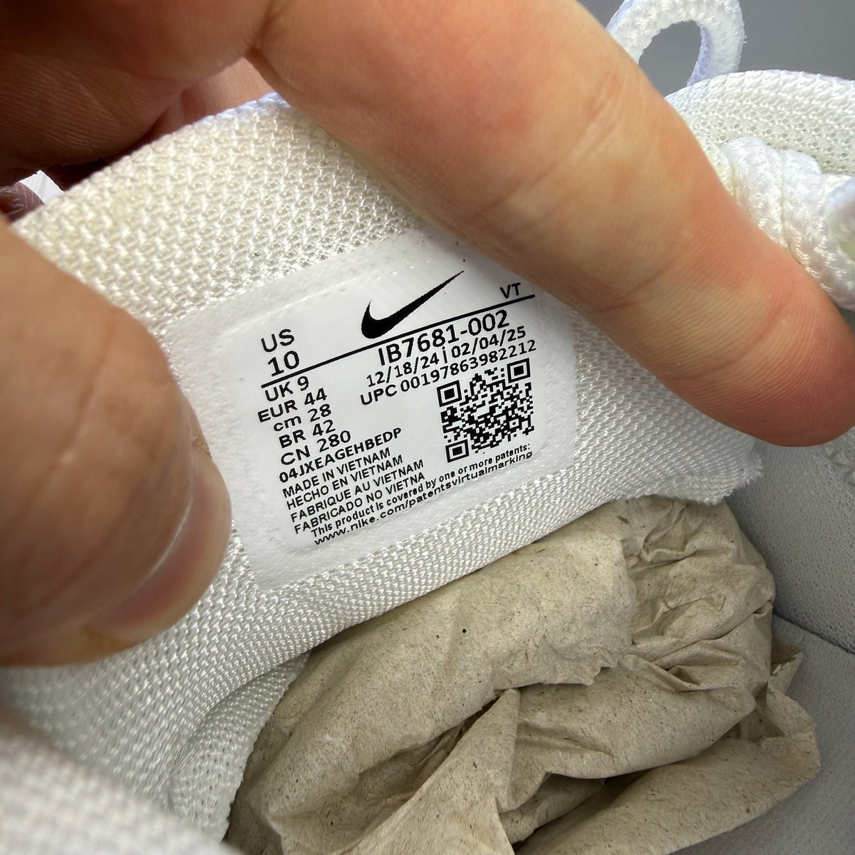 Nike Air Max 95 white trainers with grey accents and signature swoosh logo.