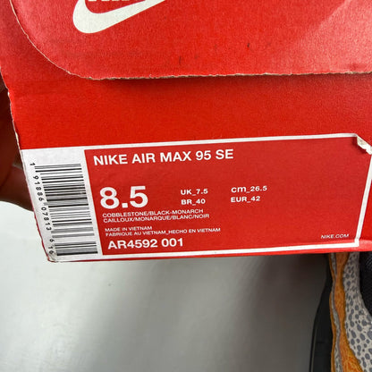 Nike Air Max 95 black trainers featuring unique safari print and signature logo.