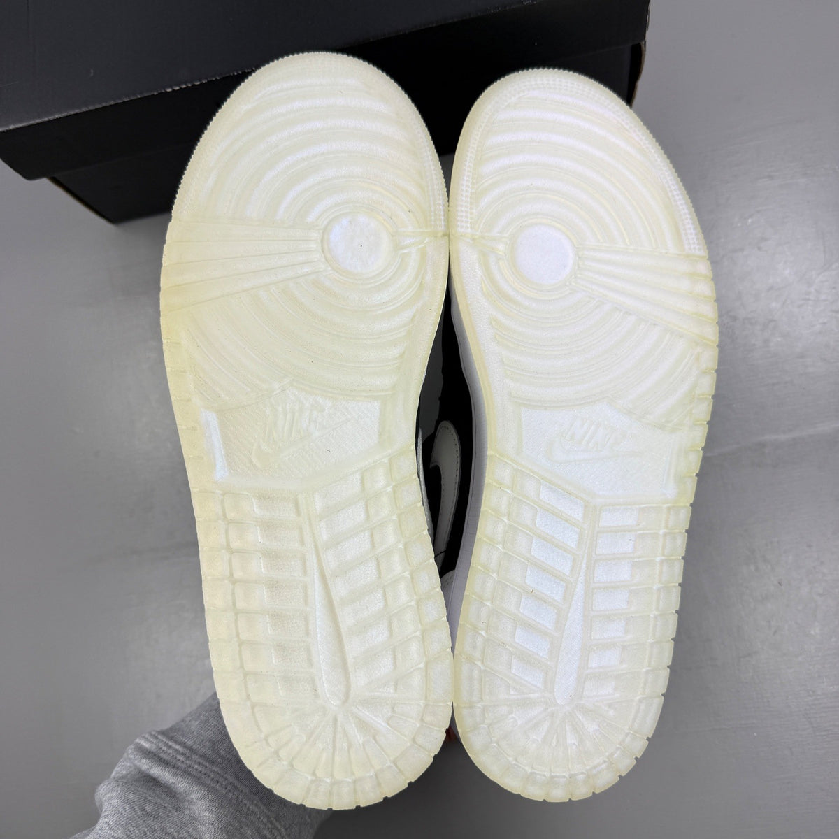 Jordan black athletic shoes with white accents and diamond pattern details.