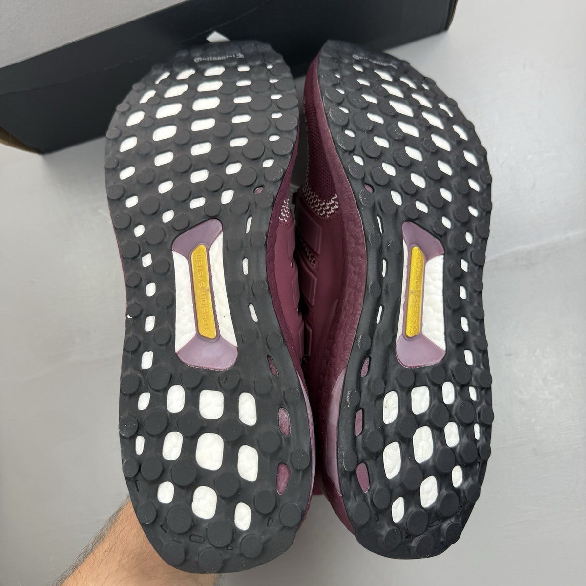 Adidas UltraBoost 1.0 DNA red trainers with signature three stripes and knit upper.