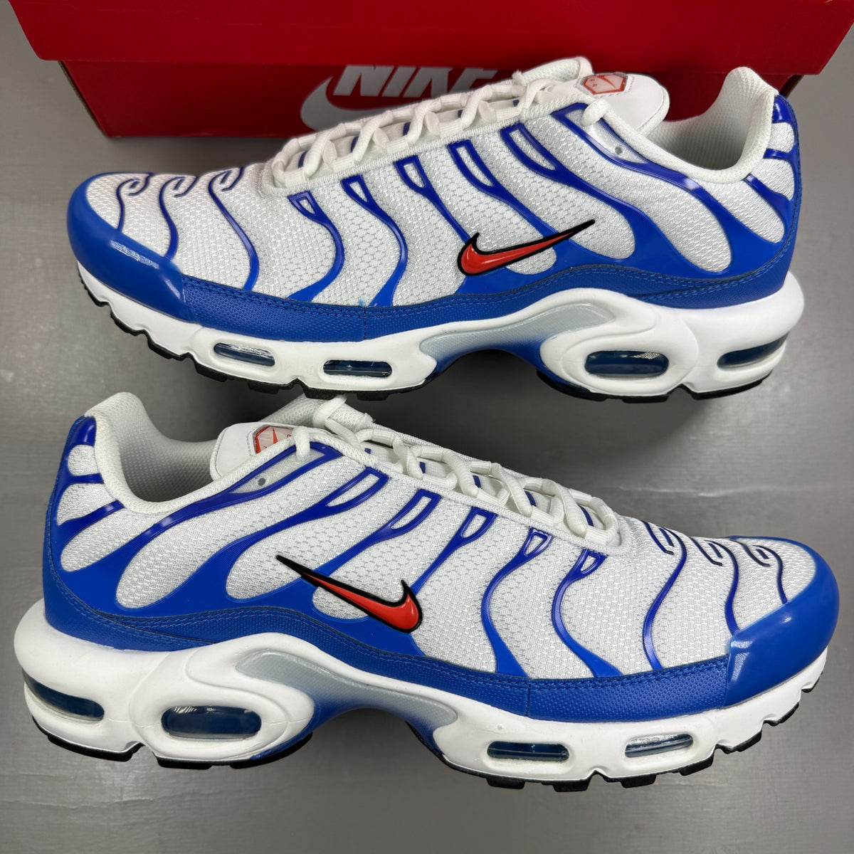 Nike running shoes white with Signal Blue accents and Air Max cushioning.