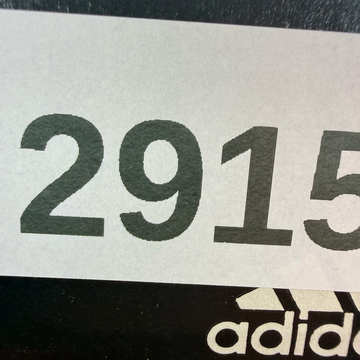 Adidas black Ultra Boost trainers with white accents and signature three-stripe logo.