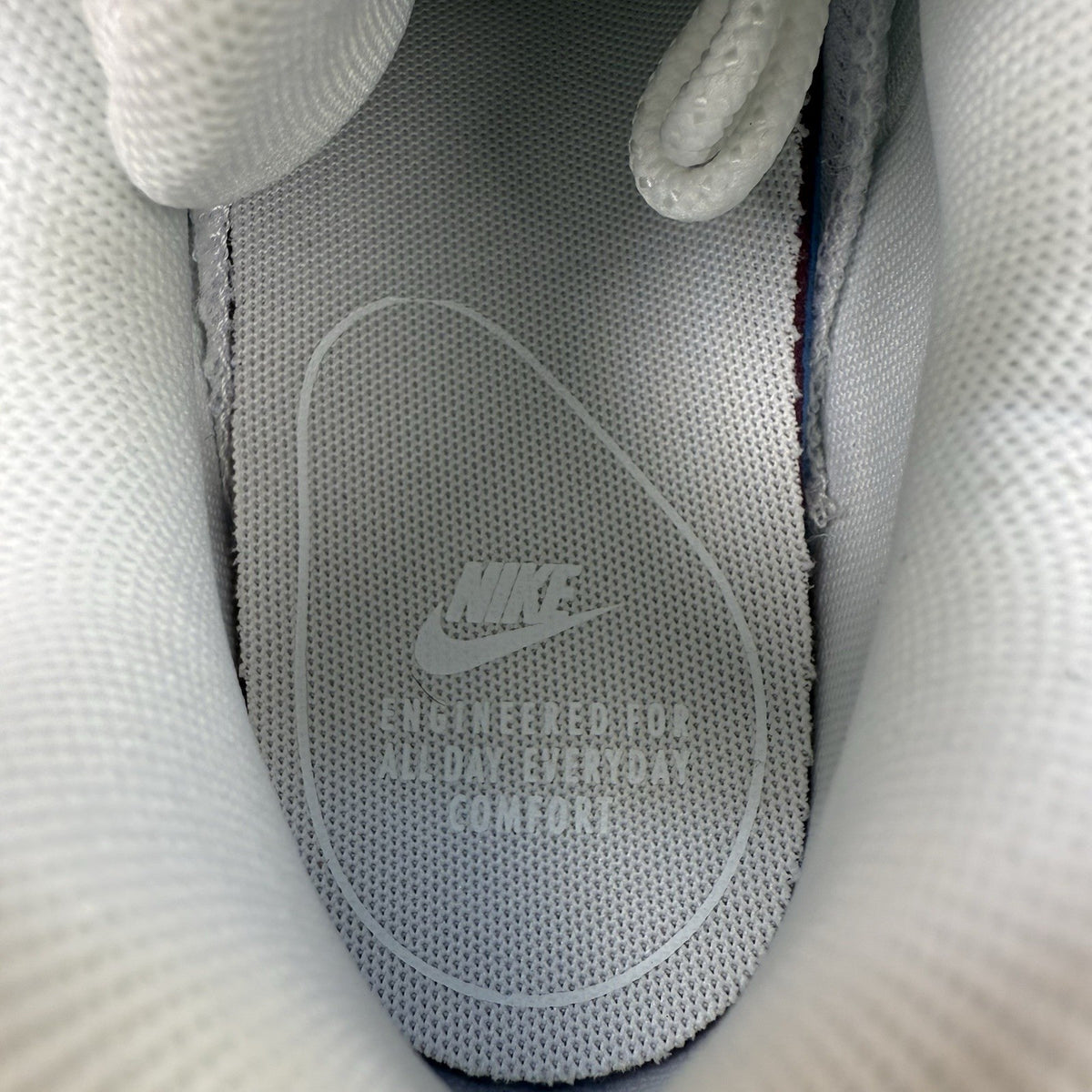 Nike Air Max 95 trainers white mesh upper with signature swoosh logo and reflective details.