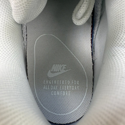 Nike Air Max 95 trainers white mesh upper with signature swoosh logo and reflective details.