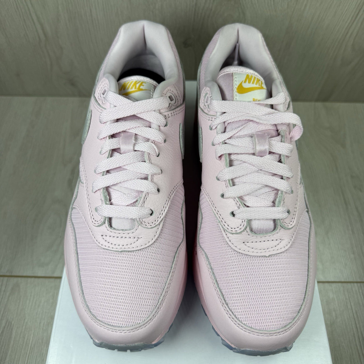 Nike Air Max 1 trainers pink with silver accents and unique design details.