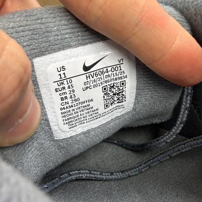 Nike Air Max 95 grey trainers with caution strip detailing and black accents.