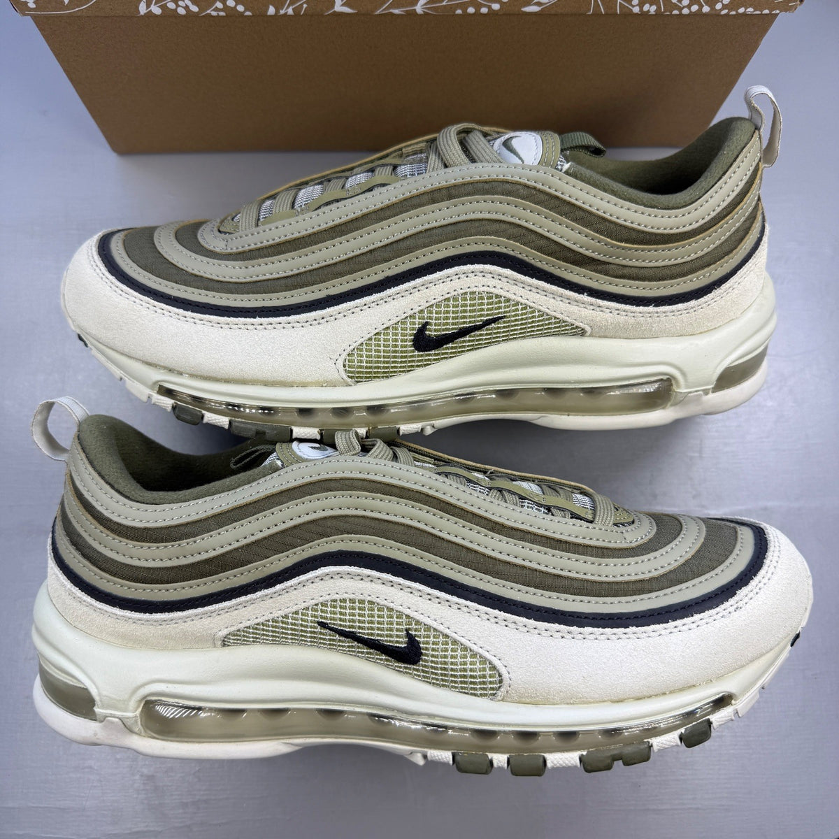 Nike trainers green with light bone accents and Air Max cushioning design.