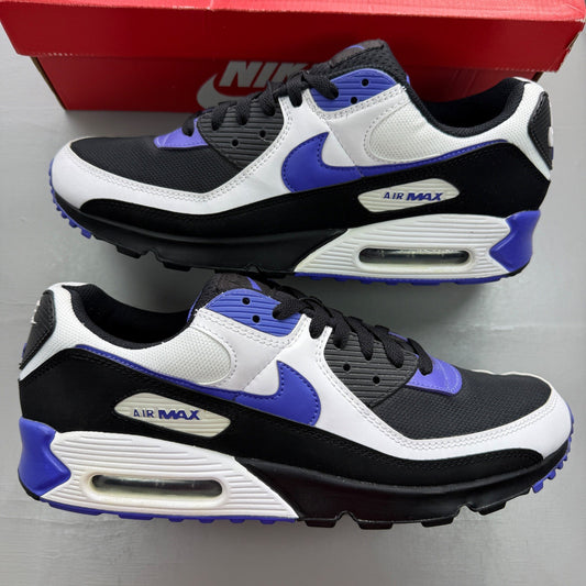 Nike Air Max 90 black trainers with purple accents and white sole, featuring logo details.