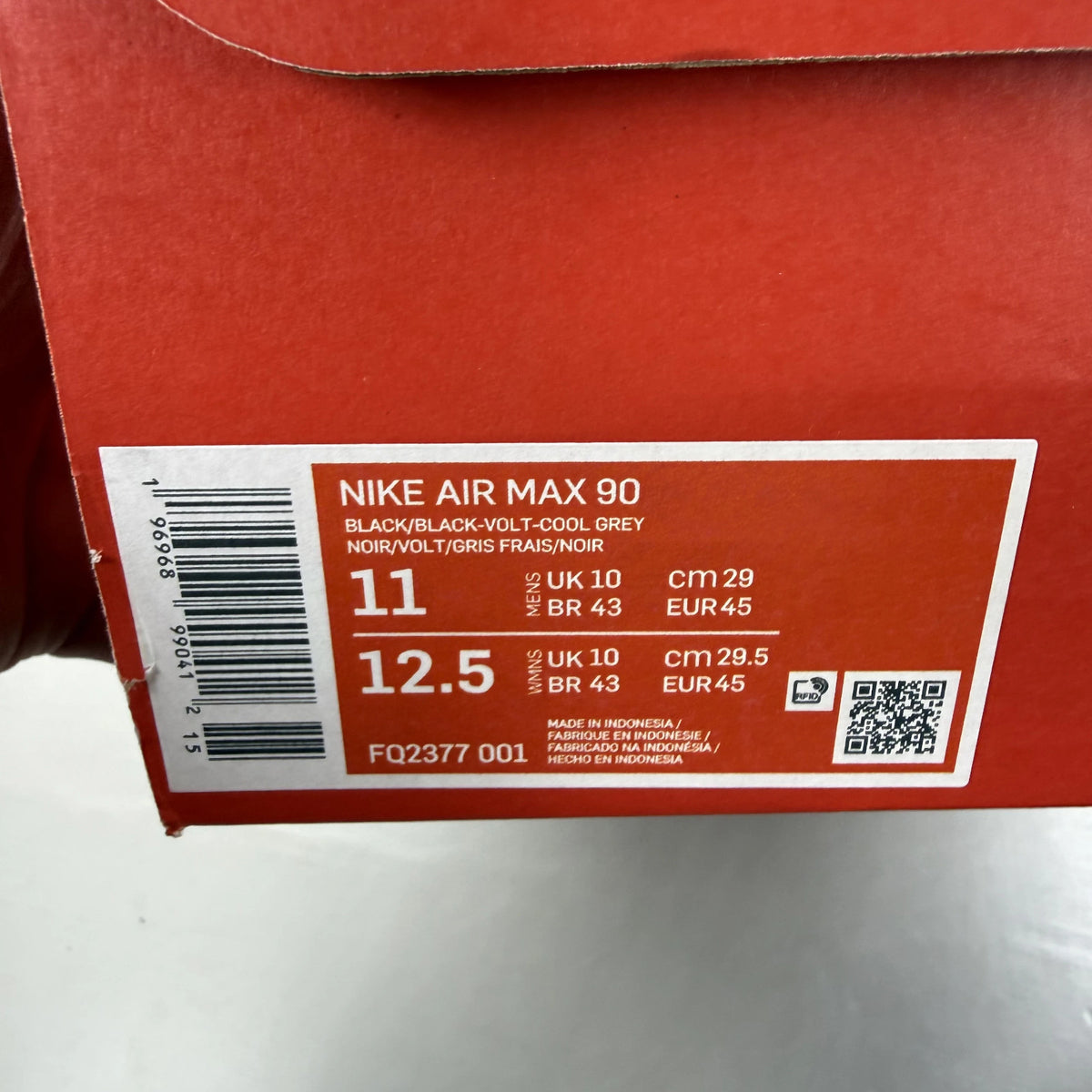 Nike Air Max 90 black trainers with volt and cool grey swoosh logo.