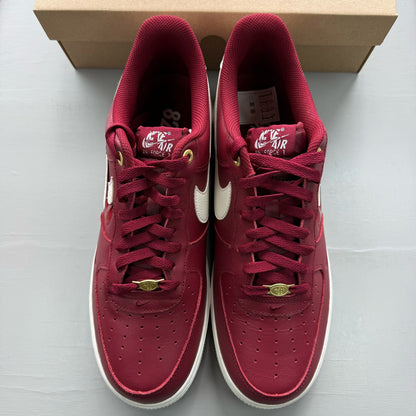 Nike Air Force 1 red trainers with premium materials and classic silhouette.