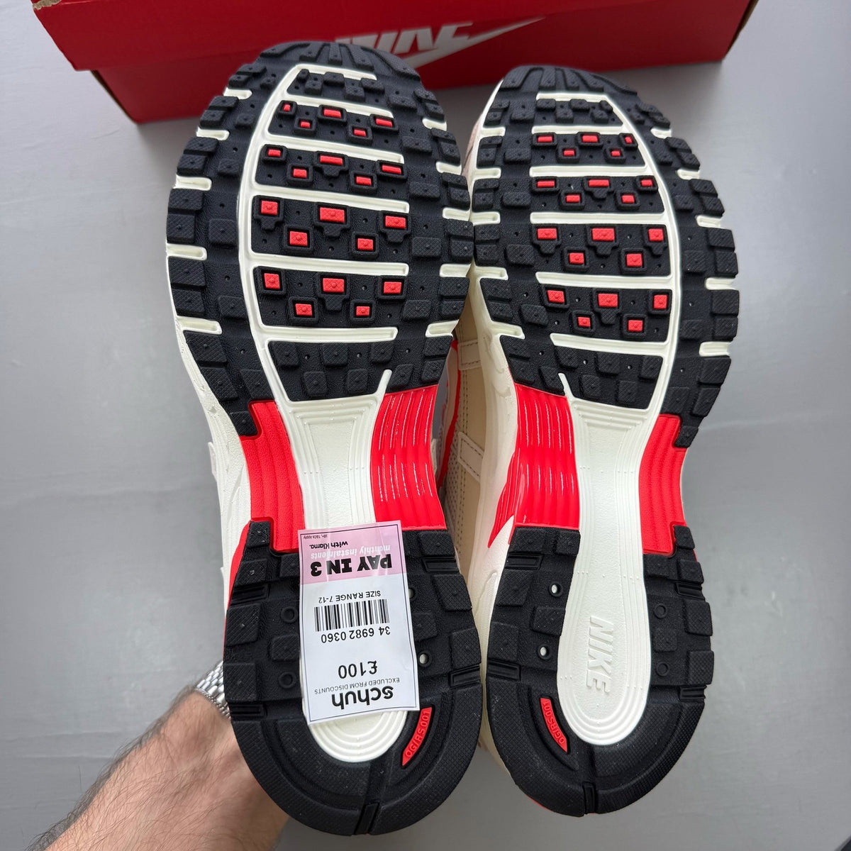Nike P-6000 trainers white with red accents and mesh detailing, brand logo on tongue.