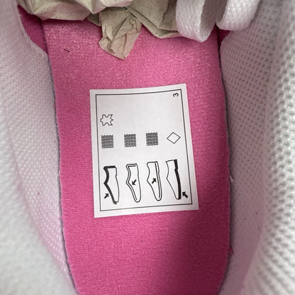 Nike white trainers with pink accents and gum sole, featuring iconic swoosh logo.