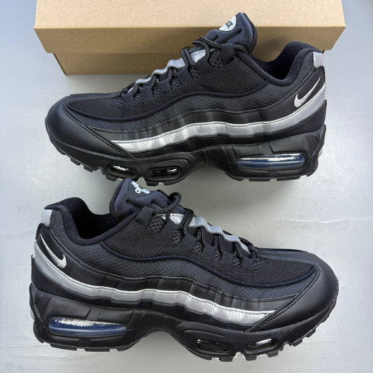 Nike trainers black with metallic silver accents and signature Air Max cushioning.