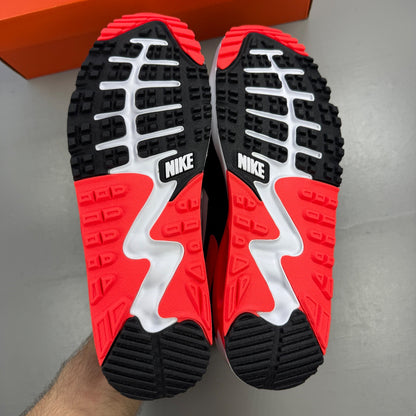 Nike trainers black with infrared accents and grey detailing, featuring Air Max cushioning.