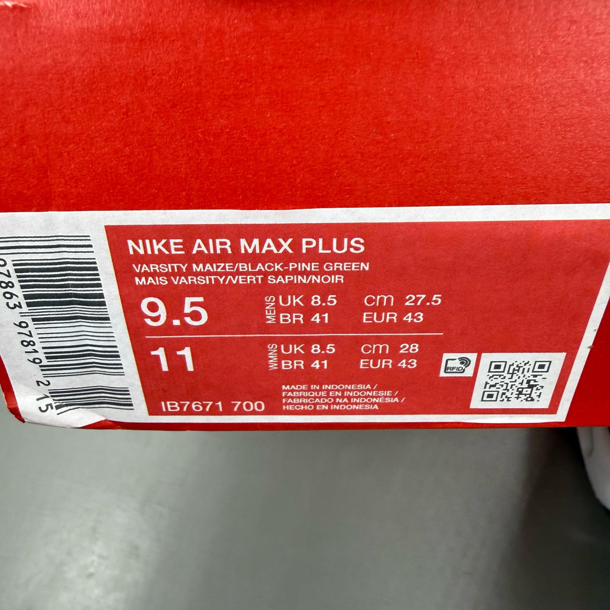 Nike Air Max Plus trainers yellow with pine green accents and logo detail.