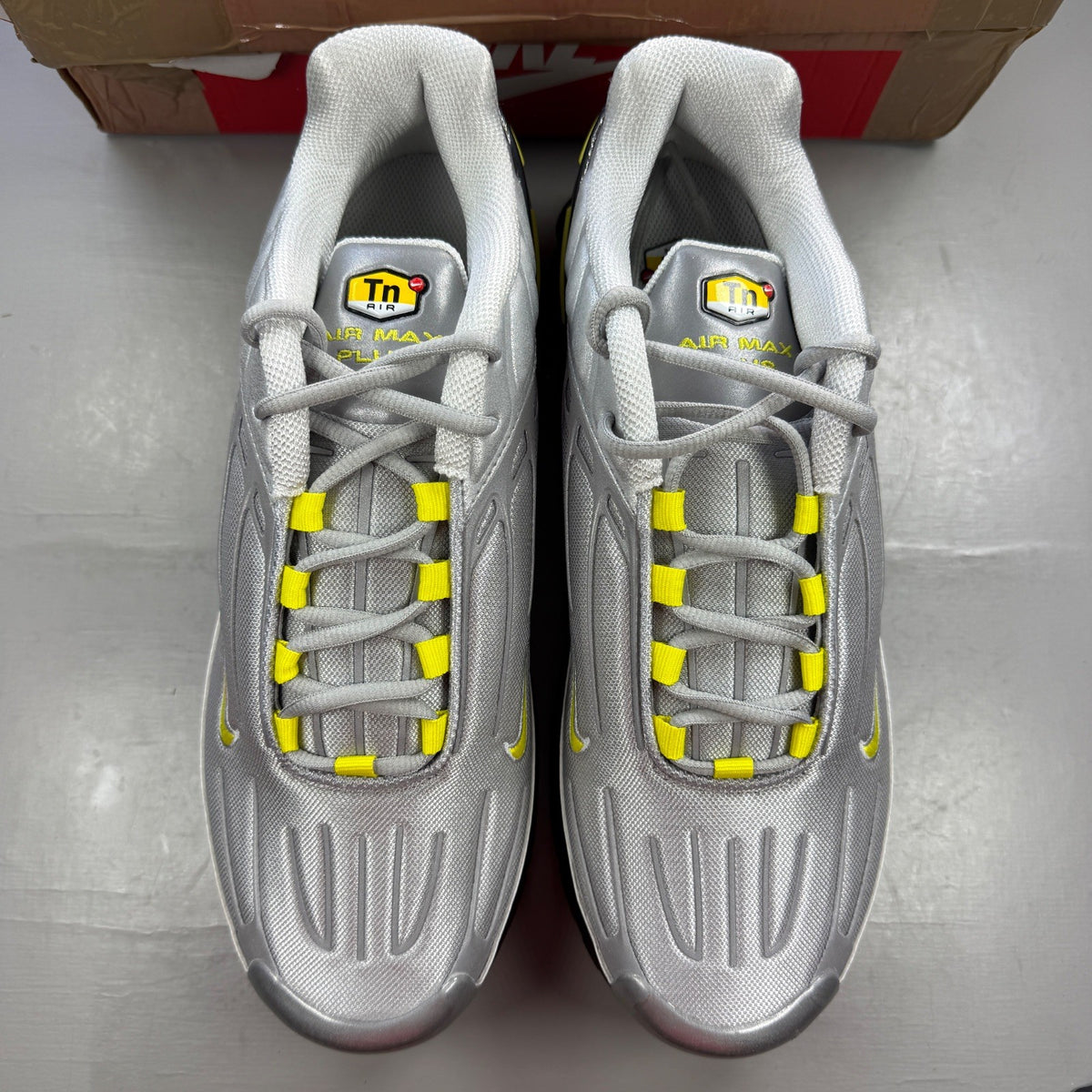 Nike Air Max Plus 3 TN metallic silver with yellow accents and logo details.