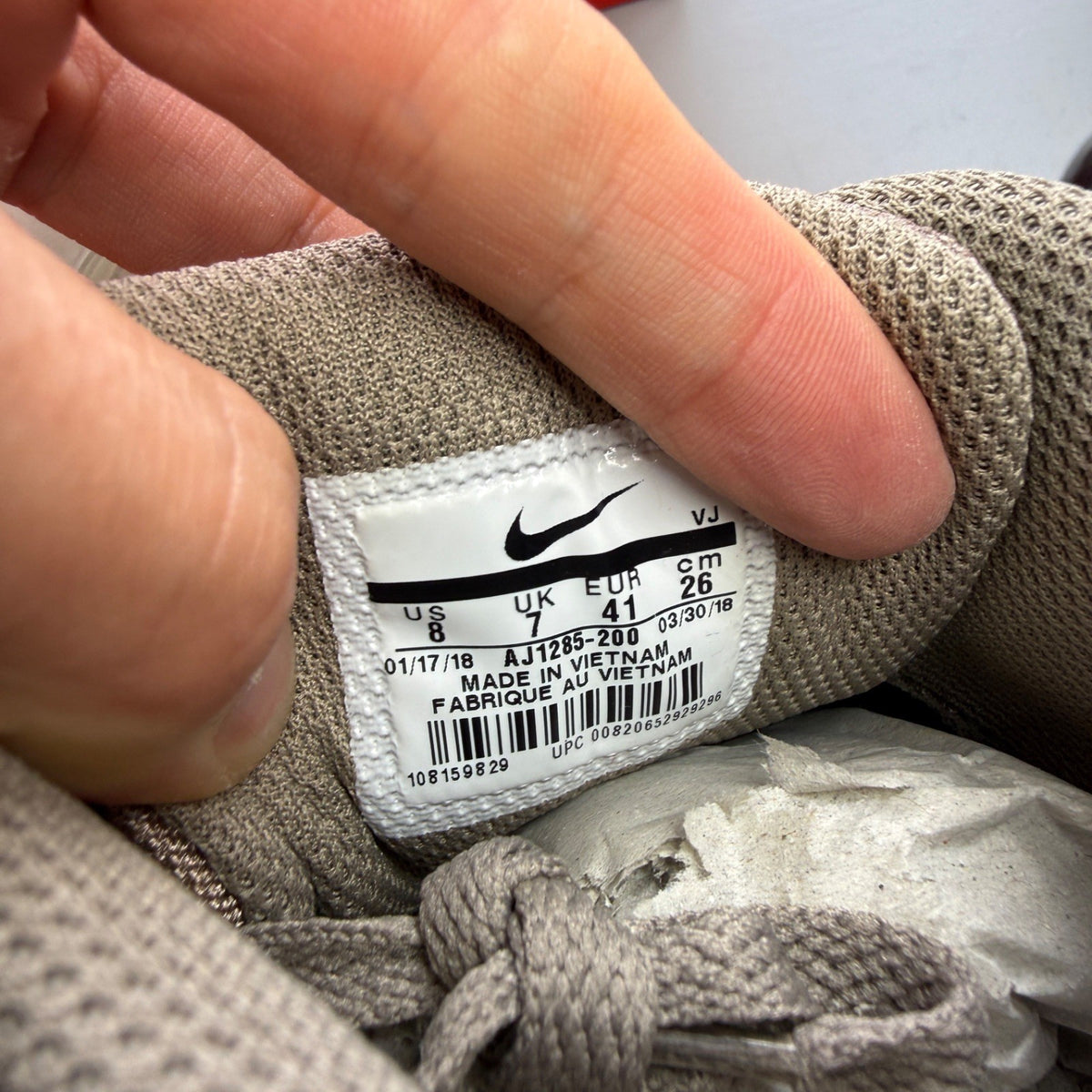 Nike beige trainers with Air Max cushioning and logo detailing.