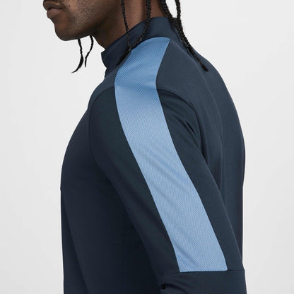 Nike blue Dri-FIT 1/4 zip top with logo and breathable material.