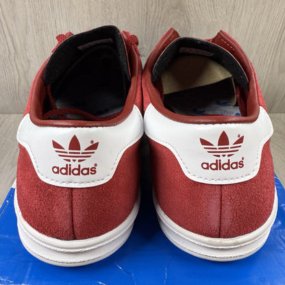 Adidas red trainers with white stripes and logo, classic suede material.