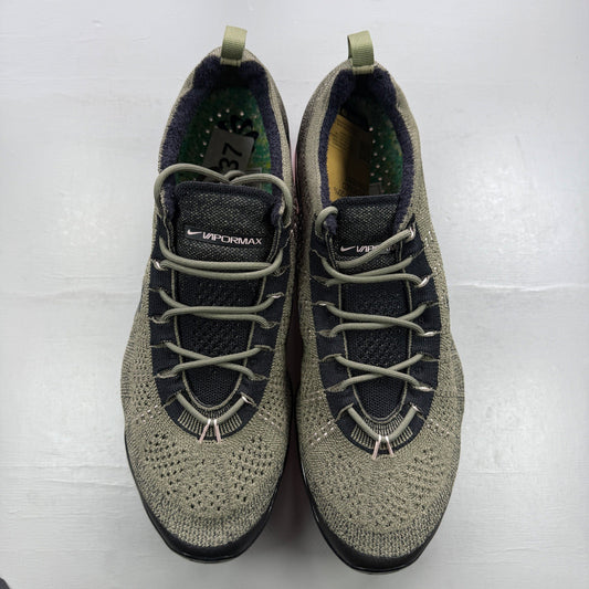 Nike trainers green Flyknit upper with pink accents and Air cushioning.