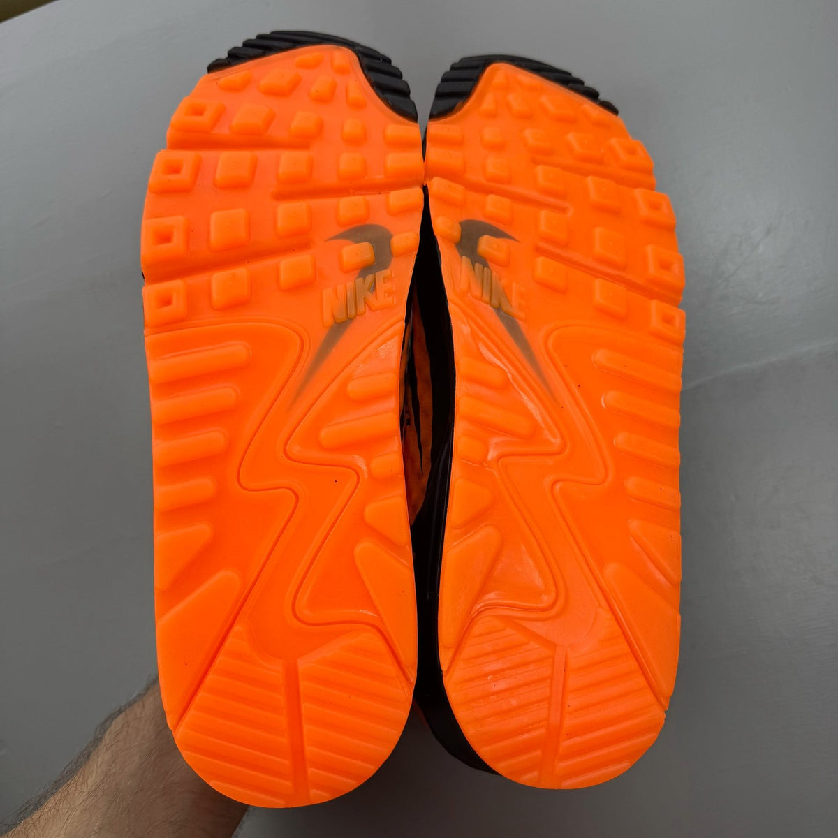 Nike black trainers with bright citrus accents and Hypervenom design details.