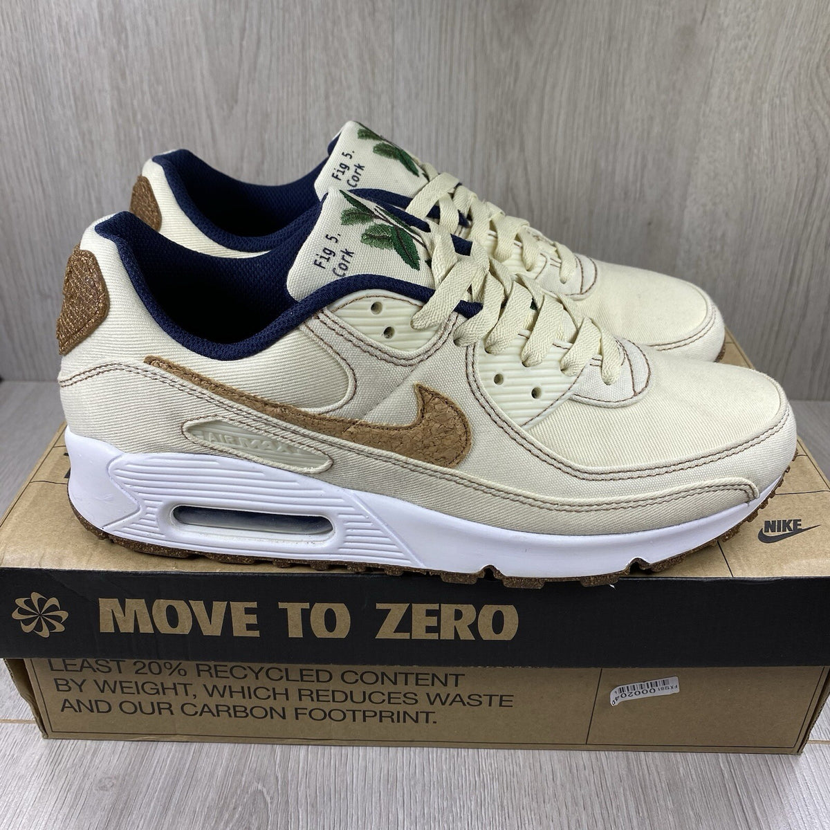 Nike Air Max 90 SE white trainers with cork accents and logo detail.