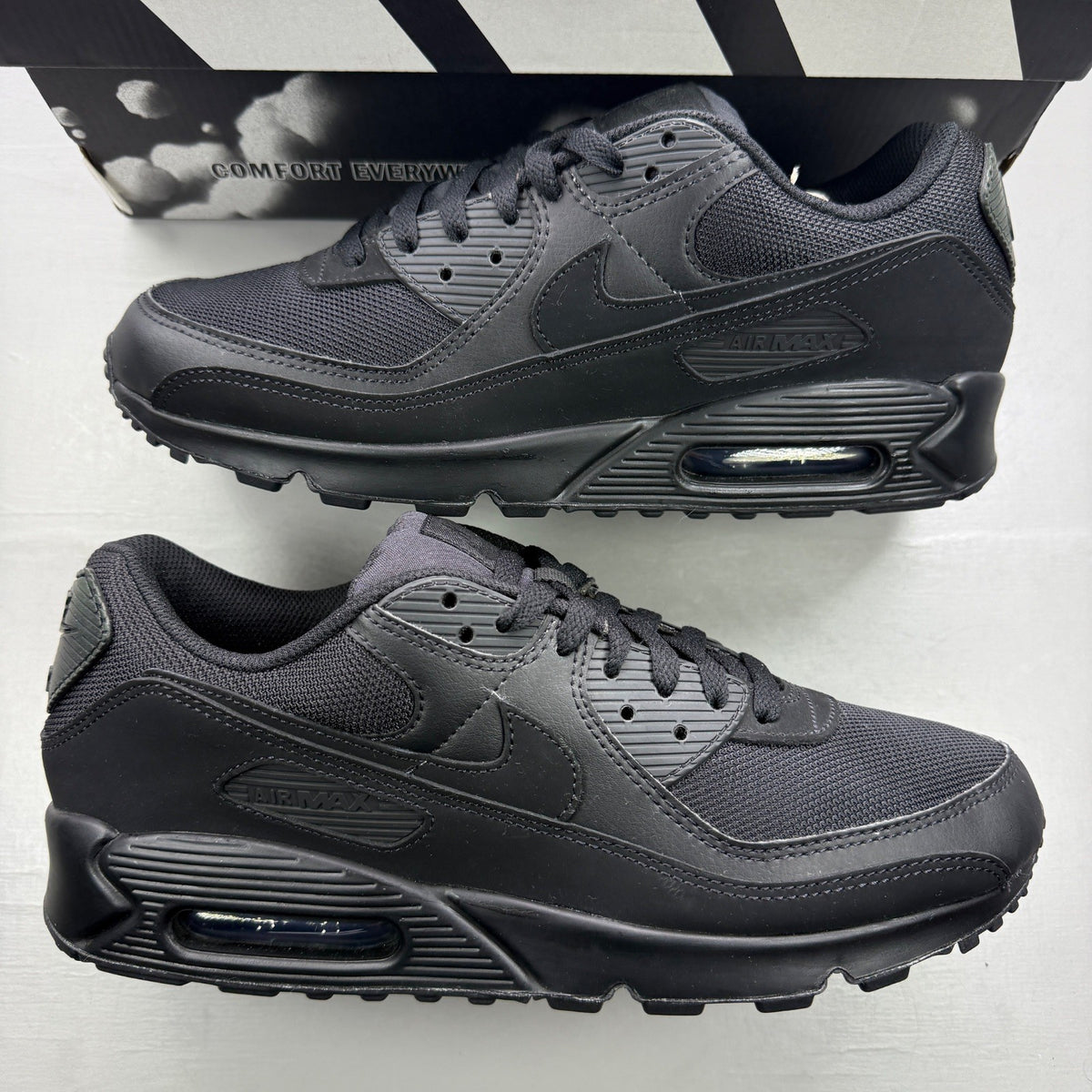 Nike trainers black with Air Max cushioning and signature swoosh logo.