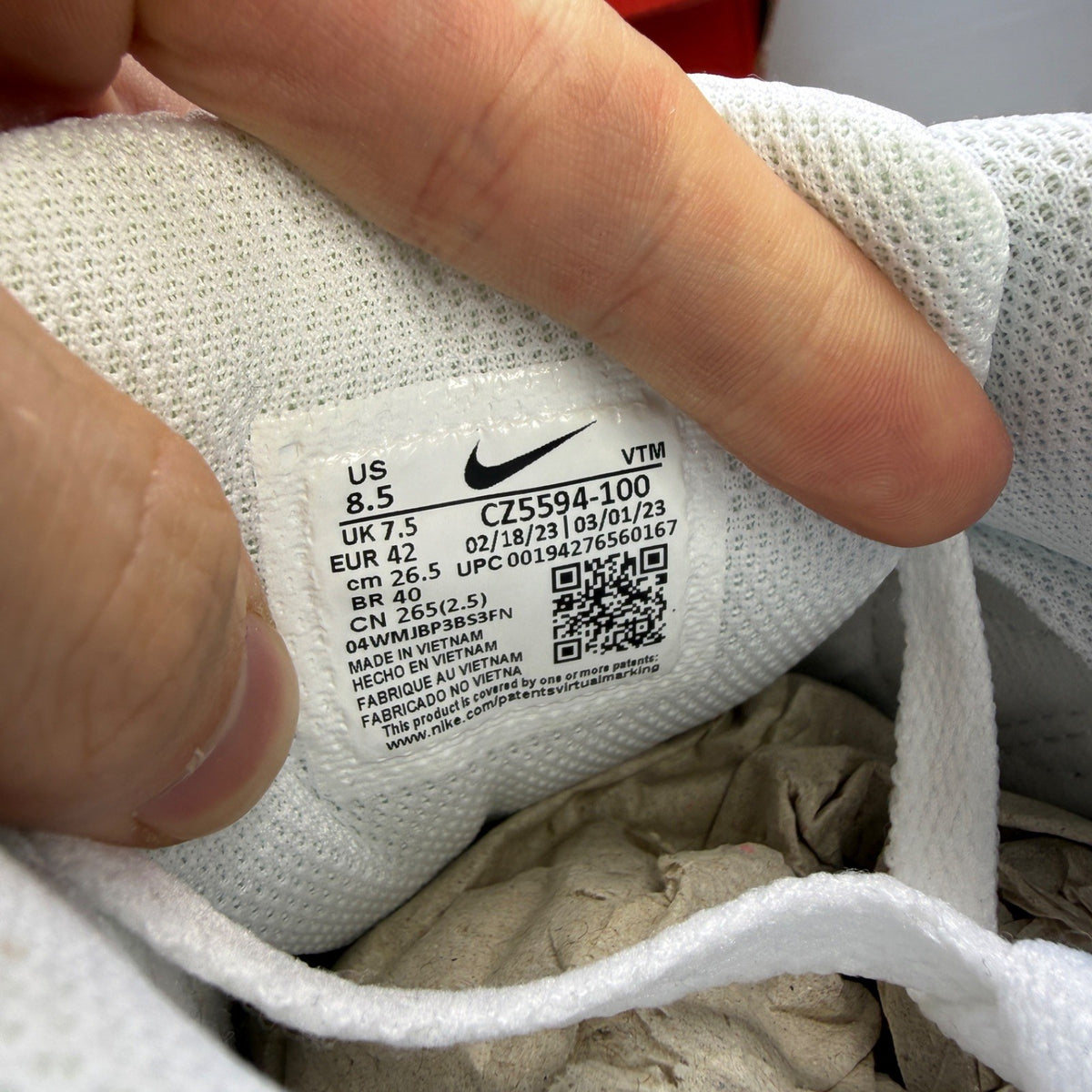 Nike deck shoes white leather with logo and minimalist design.