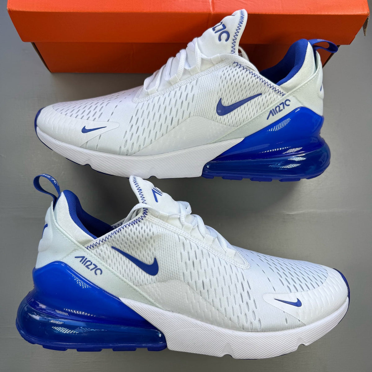 Nike Air Max 270 white trainers with racer blue accents and logo detail.