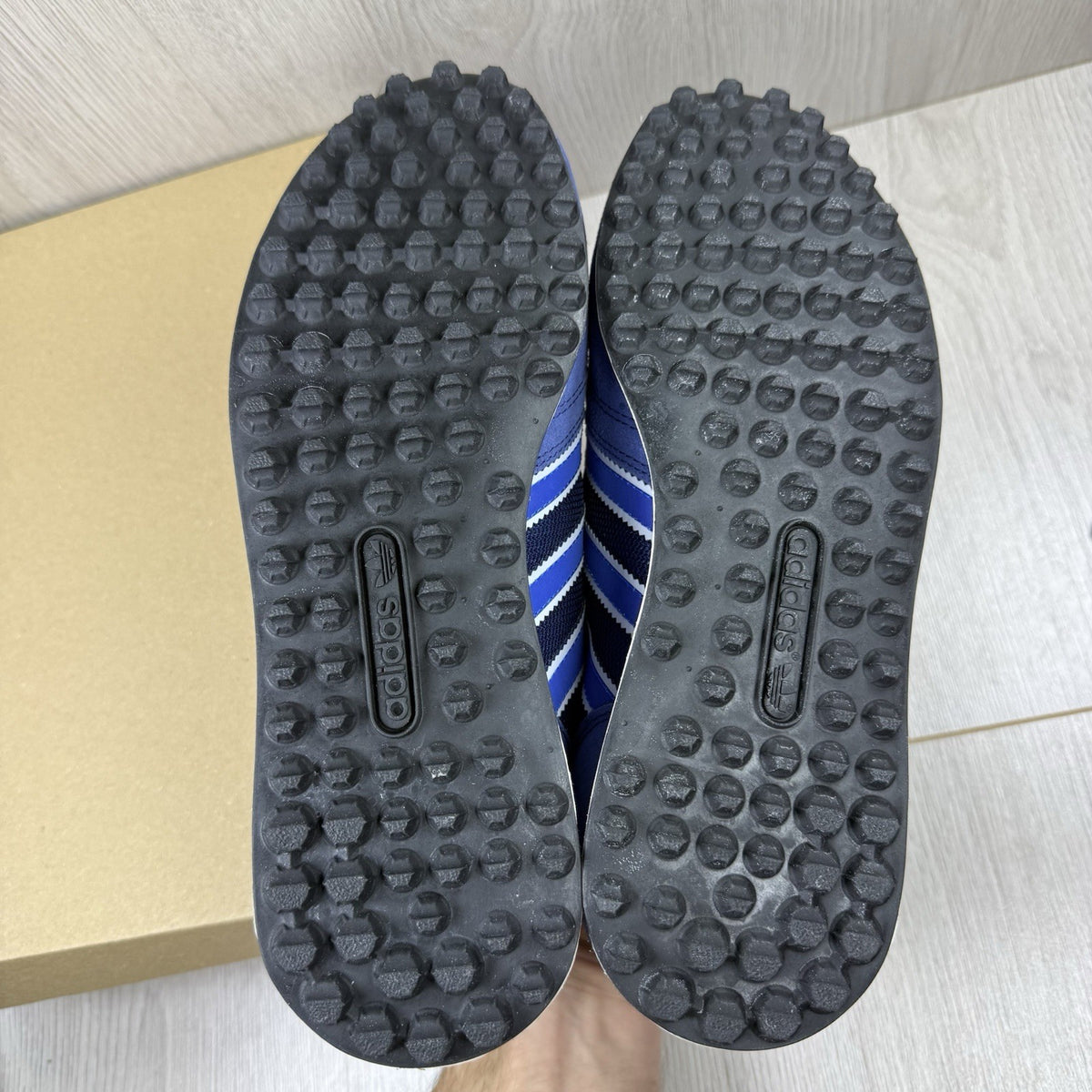Adidas blue LA Trainers with white stripes and logo detailing on the side.