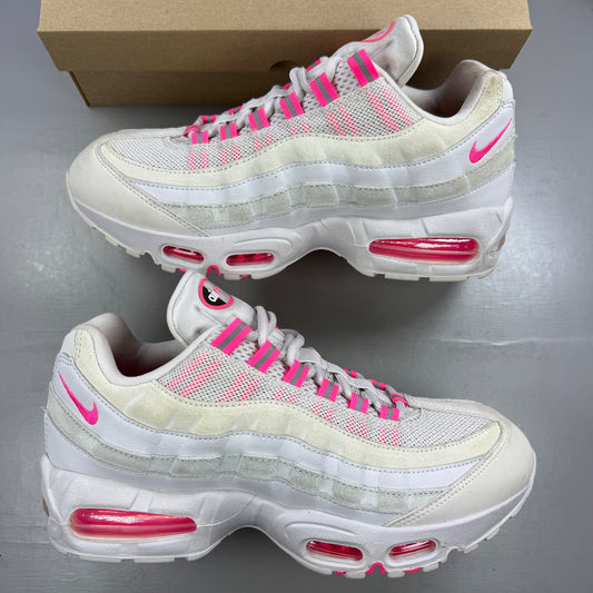 Nike running shoes white with pink accents and visible logo details.