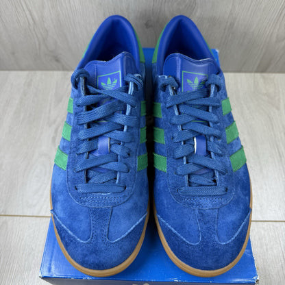 Adidas blue trainers with gum sole and iconic three-stripe logo design.