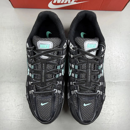 Nike black trainers with Cool Grey and Hyper Turquoise accents, featuring a sleek design.
