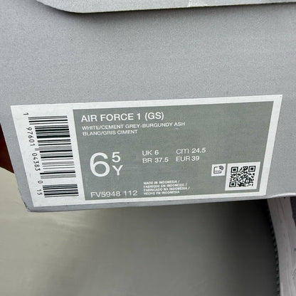 Nike Air Force 1 low white trainers with grey cement accents and logo detailing.