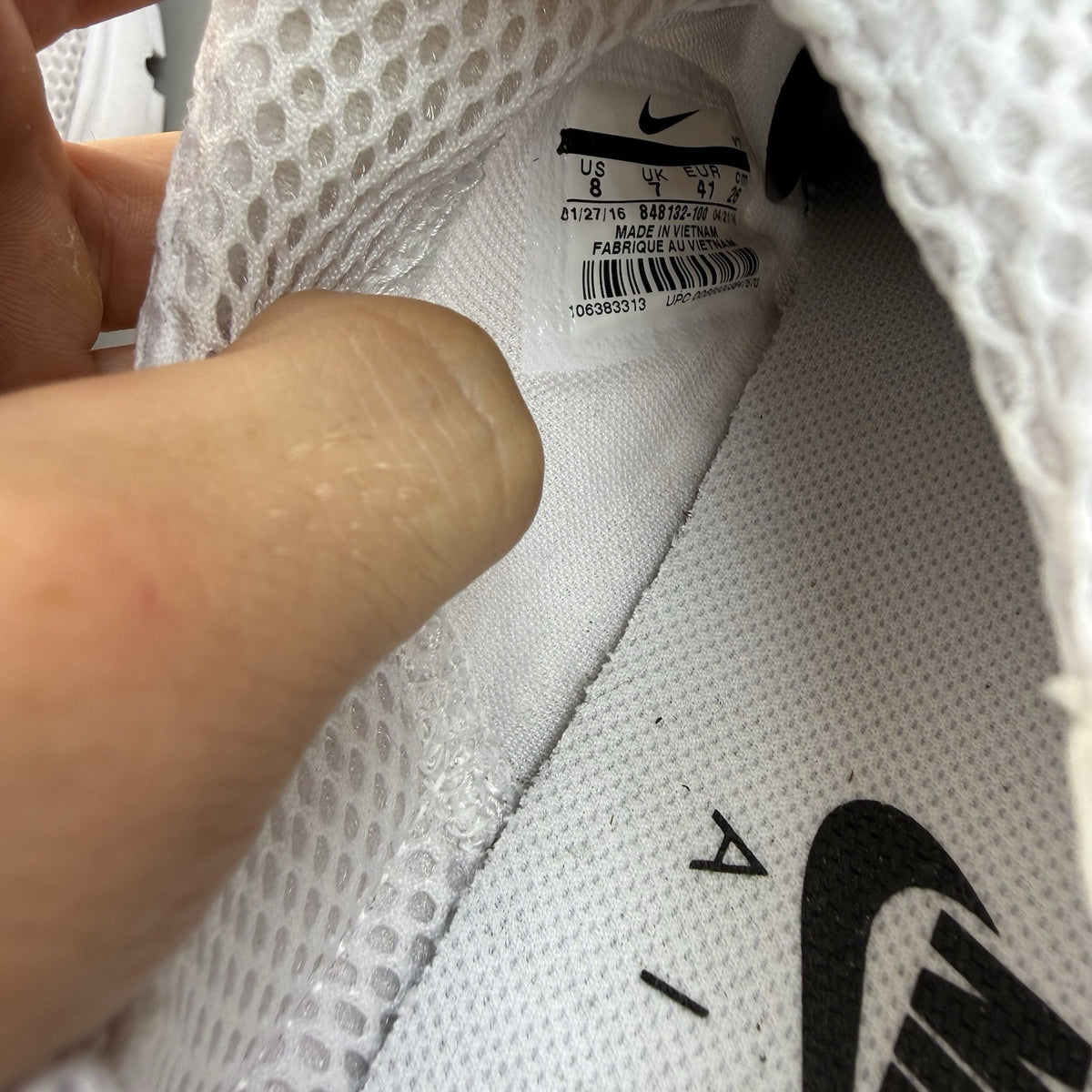 Nike Air Presto white trainers with black accents and mesh upper.