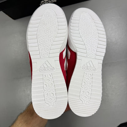 Adidas red suede running trainers with white logo and classic design details.