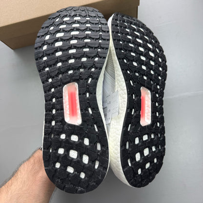 Adidas Ultra Boost 20 white running trainers with mesh upper and signature three stripes.