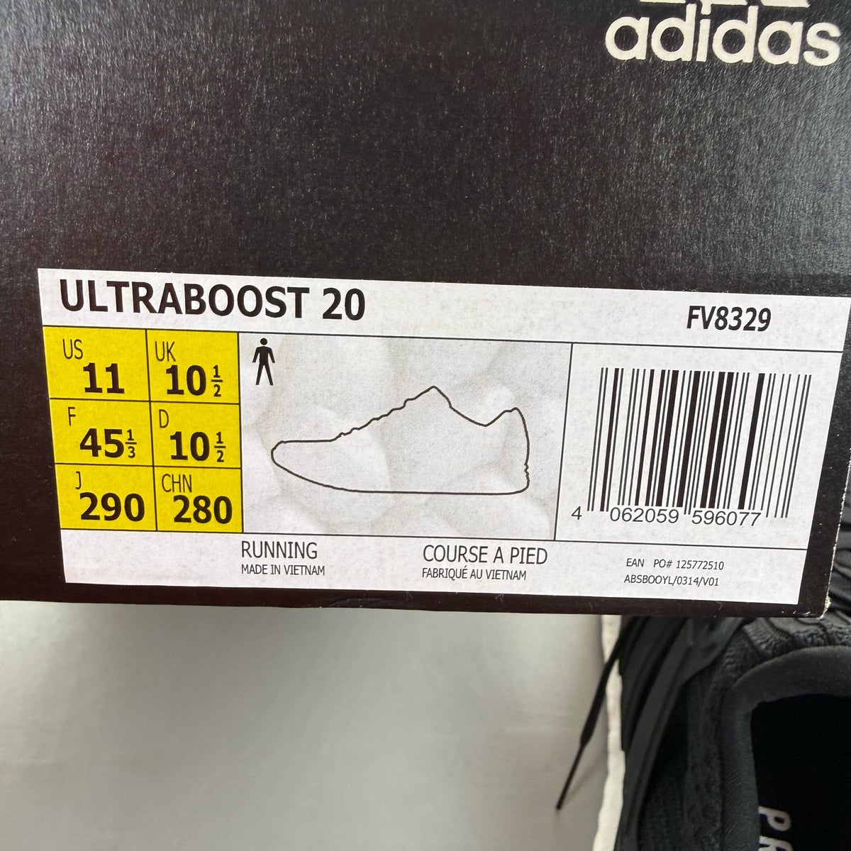 Adidas black Ultra Boost trainers with white accents and signature three-stripe logo.