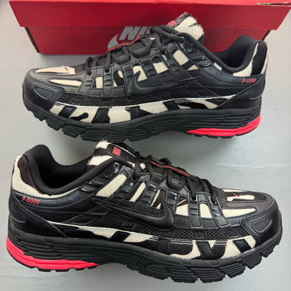 Nike black trainers with zebra pattern, solar red accents, and white detailing.