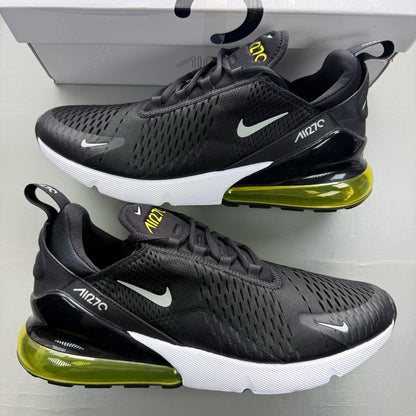 Nike black trainers with Opti Yellow accents and Air Max cushioning.