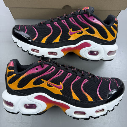 Nike Air Max Plus TN black trainers with active pink and white accents, logo detailing.