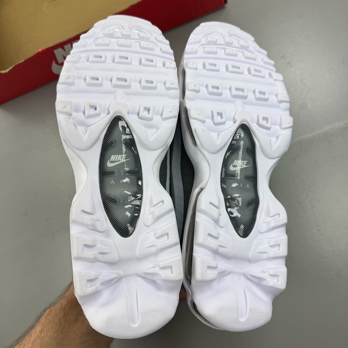 Nike Air Max 95 Ultra white trainers with grey accents and signature logo details.