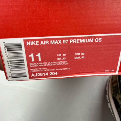 Nike black Air Max 97 trainers with country camo pattern and logo details.