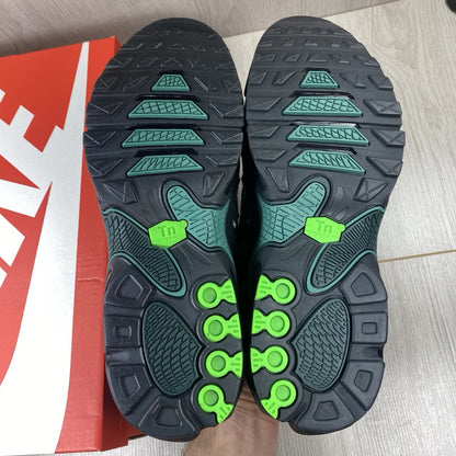 Nike Air Max Plus trainers black with volt green accents and signature swoosh logo.