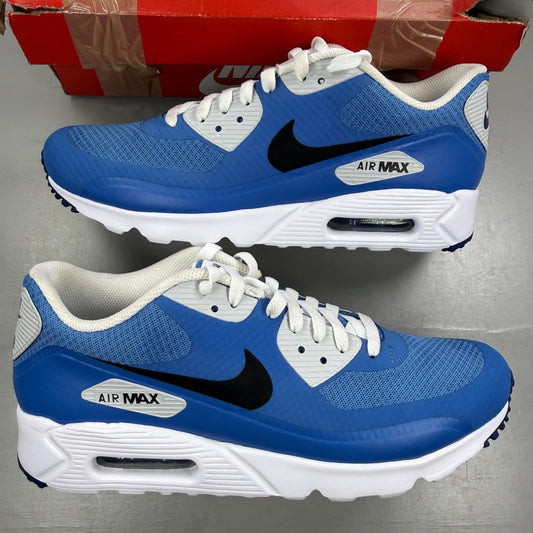 Nike Air Max 90 blue trainers with white accents and signature swoosh logo.