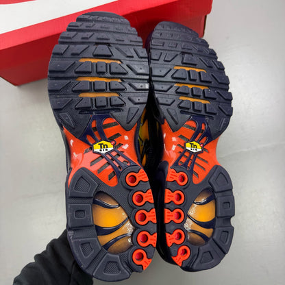 Nike yellow trainers with Hyper Crimson accents and distinctive Air Max Plus design.